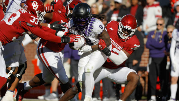 Nov 24, 2023; Norman, Oklahoma, USA; Oklahoma Sooners defensive lineman R Mason Thomas (32) tackles TCU Horned Frogs running back Emani Bailey (9) at Gaylord Family-Oklahoma Memorial Stadium.
